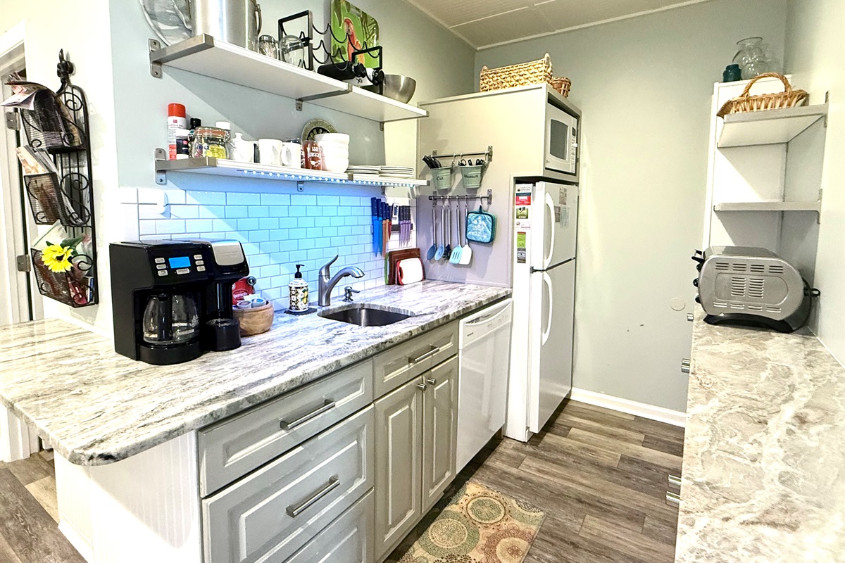 Kitchen with toaster oven, coffee maker, microwave / convection oven, dishwasher.