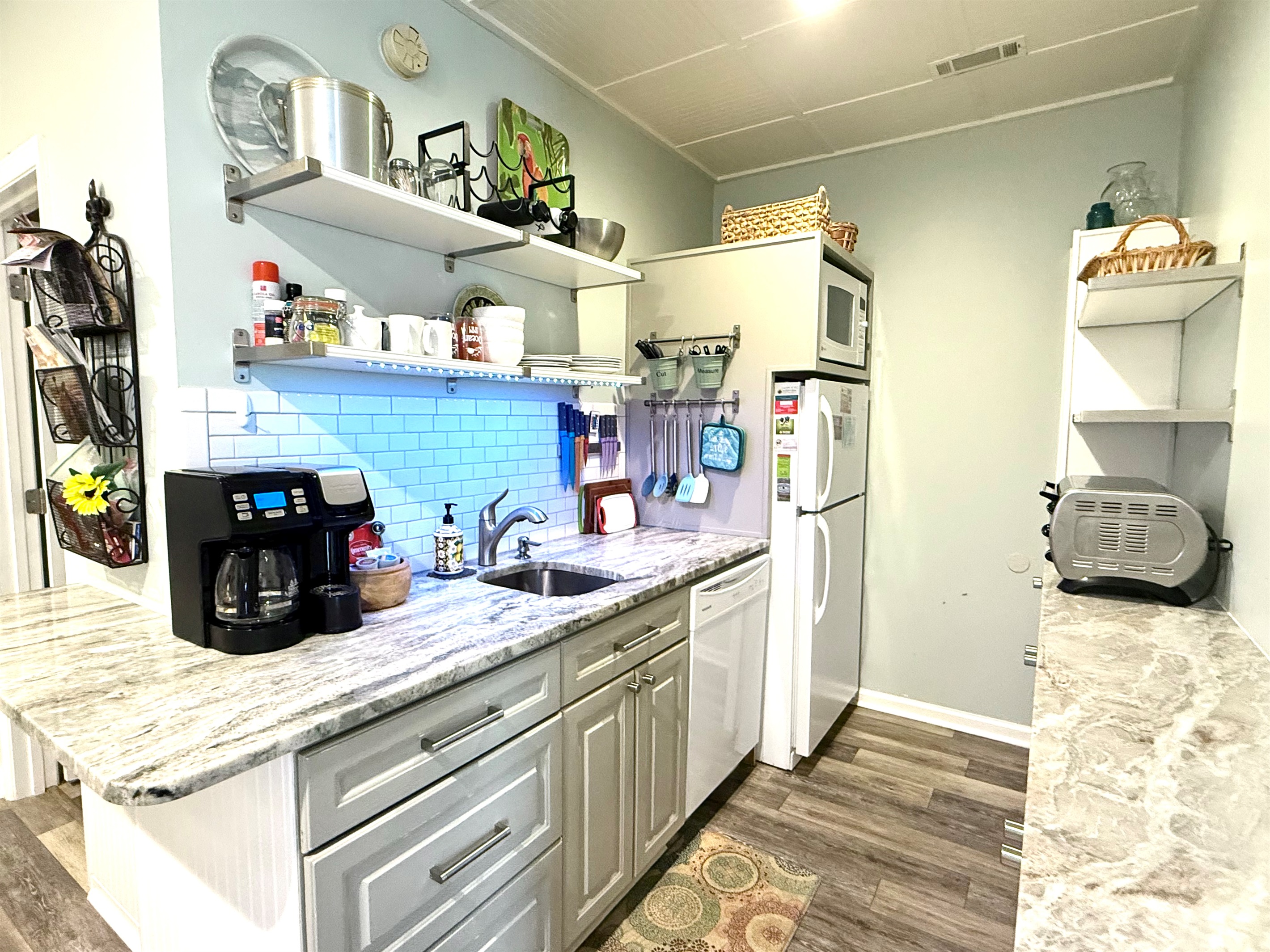 Kitchen with toaster oven, coffee maker, microwave / convection oven, dishwasher.