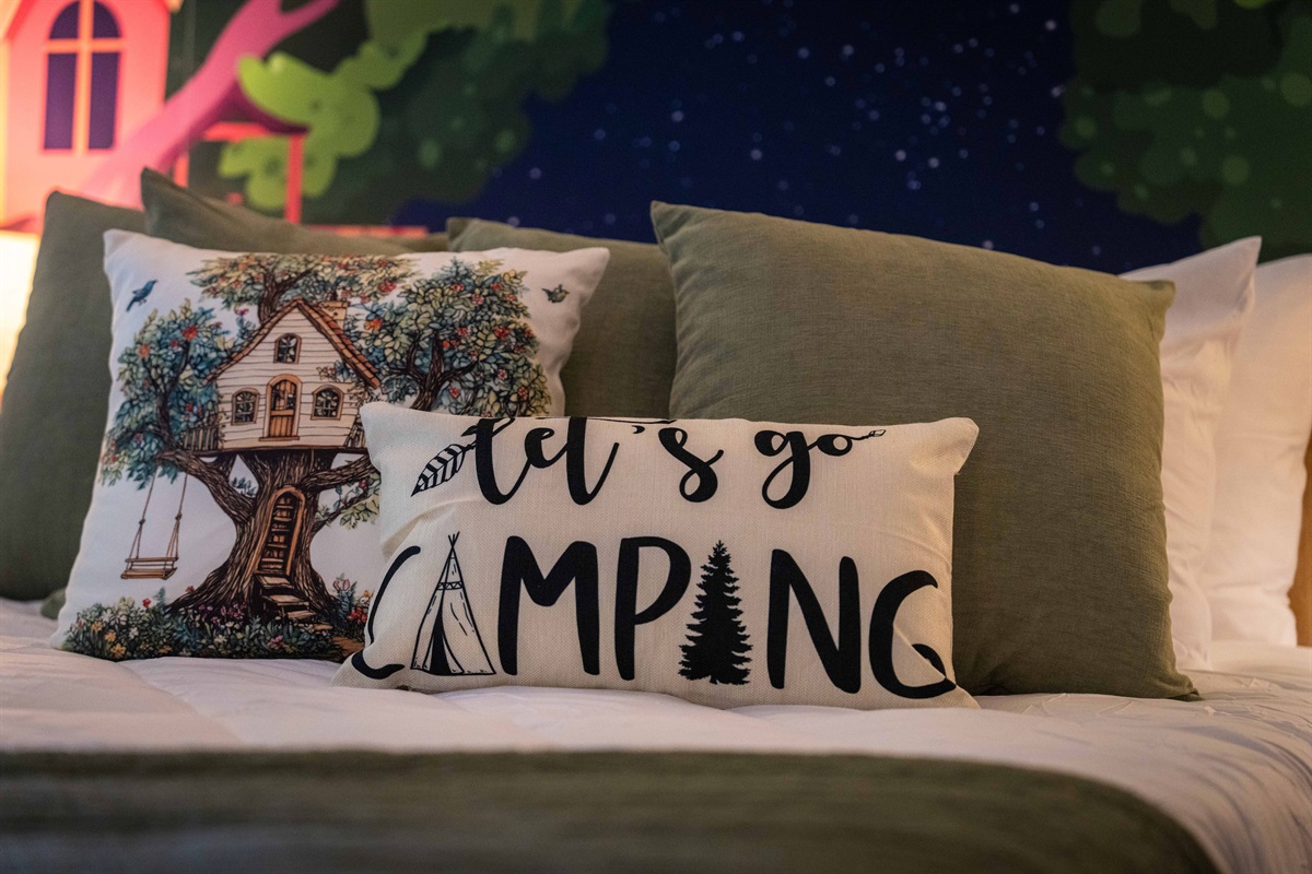 Charming pillows and nature-themed decor make this room a cozy woodland escape.