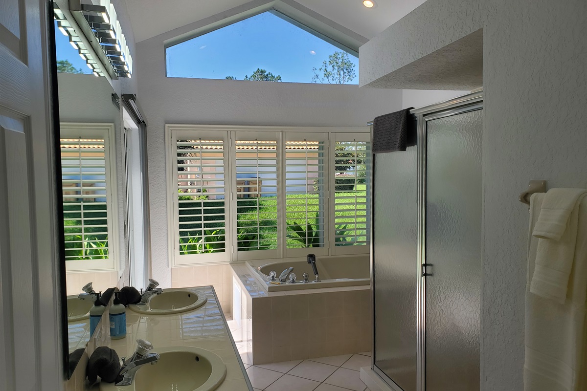 King ensuite bathroom with walk in shower, double sinks, jet tub and toilet