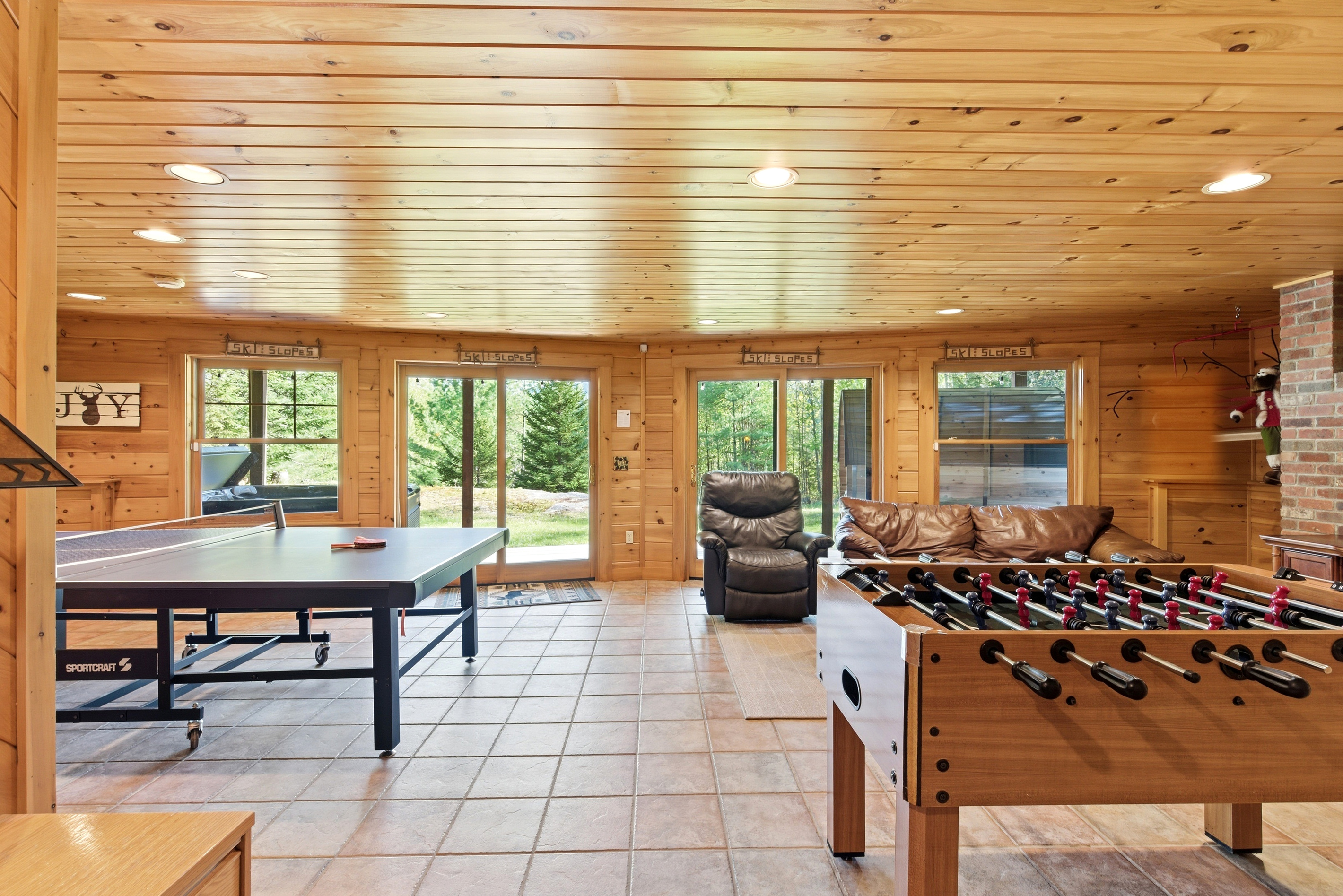 Bring everyone together in the spacious game room featuring multiple entertainment options.