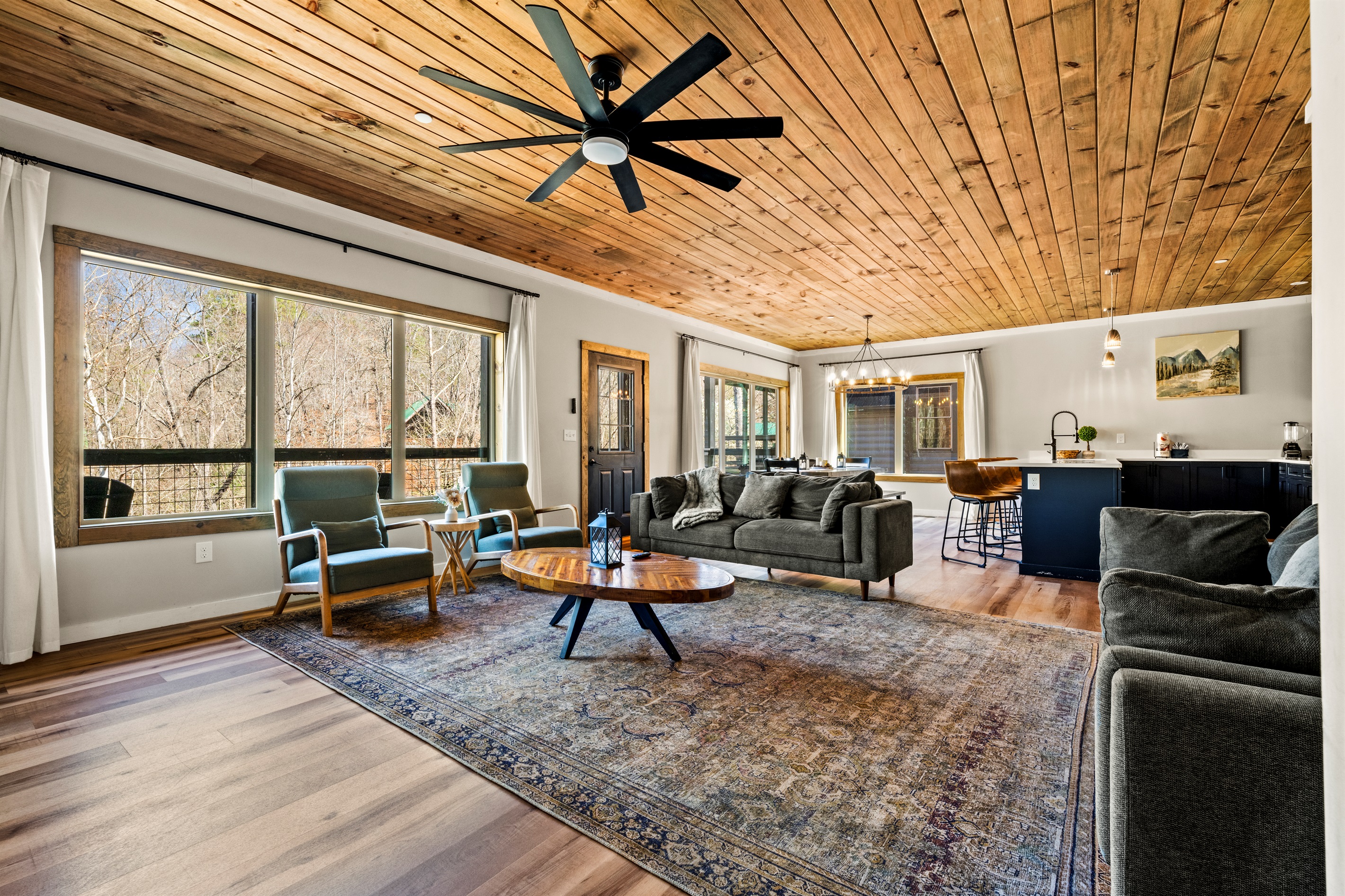 The spacious living room has large windows that open the space and let in plenty of natural light.