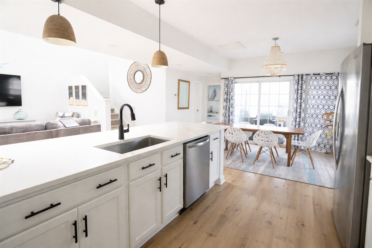 A bright, open kitchen with a perfect view of the living and dining areas. Stay connected while cooking and entertaining