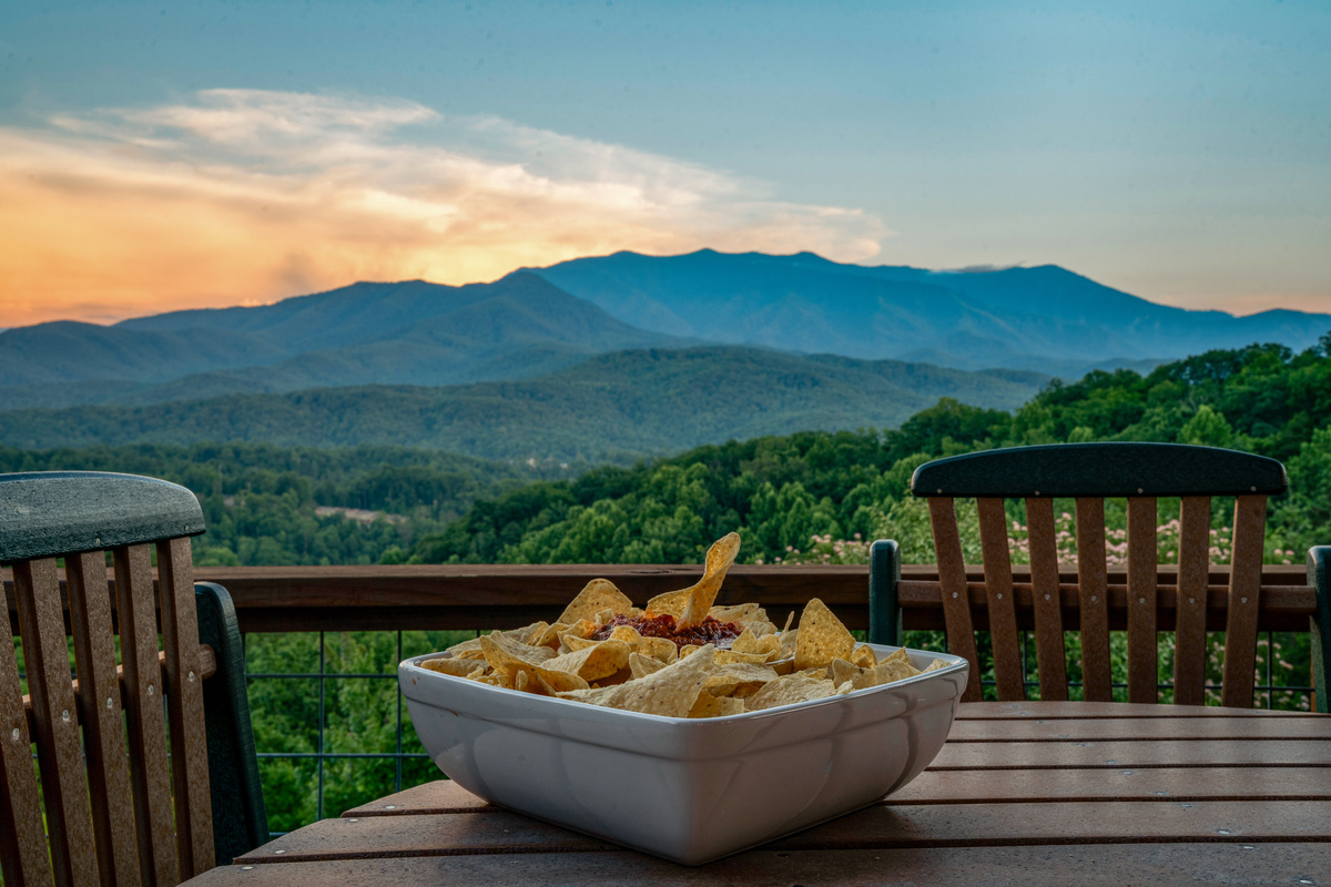 Enjoy dinner on the back deck with outside table and  high back chairs with the best view ever of the Smokies
