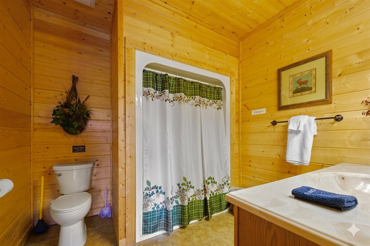 Bathroom #3 Step into your peaceful a full shower/tub combination, where warm wood surrounds you in rustic calm. Perfect for a relaxing soak or a refreshing start to your mountain morning.