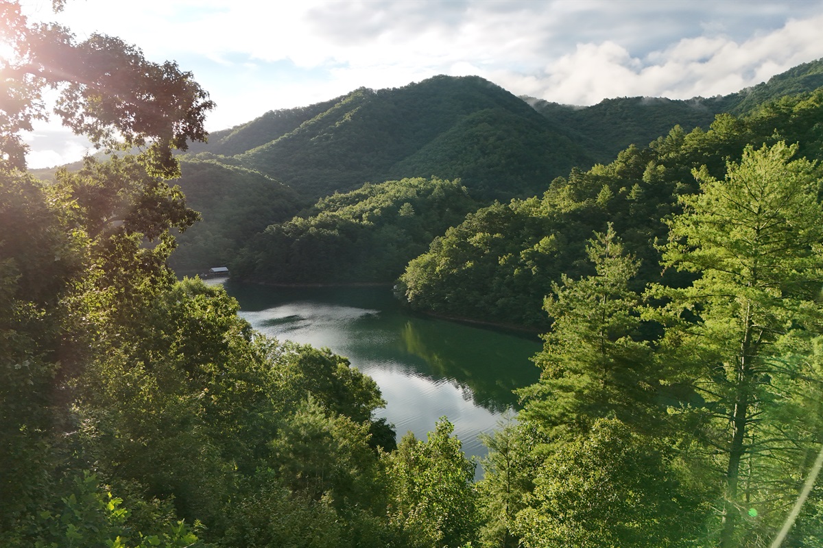 Stunning View: Gaze over the serene waters and lush mountains from your own private balcony!