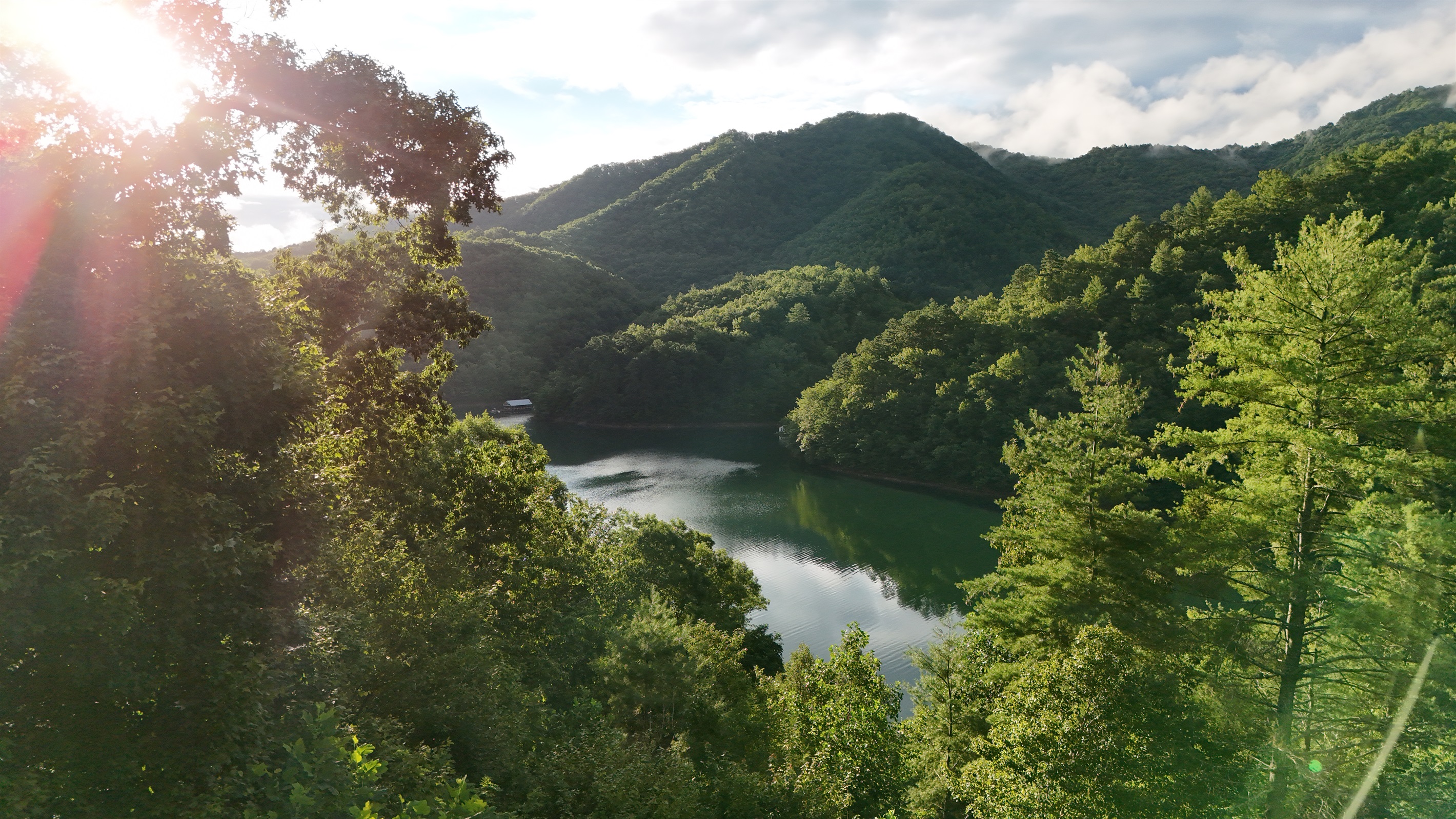 Stunning View: Gaze over the serene waters and lush mountains from your own private balcony!