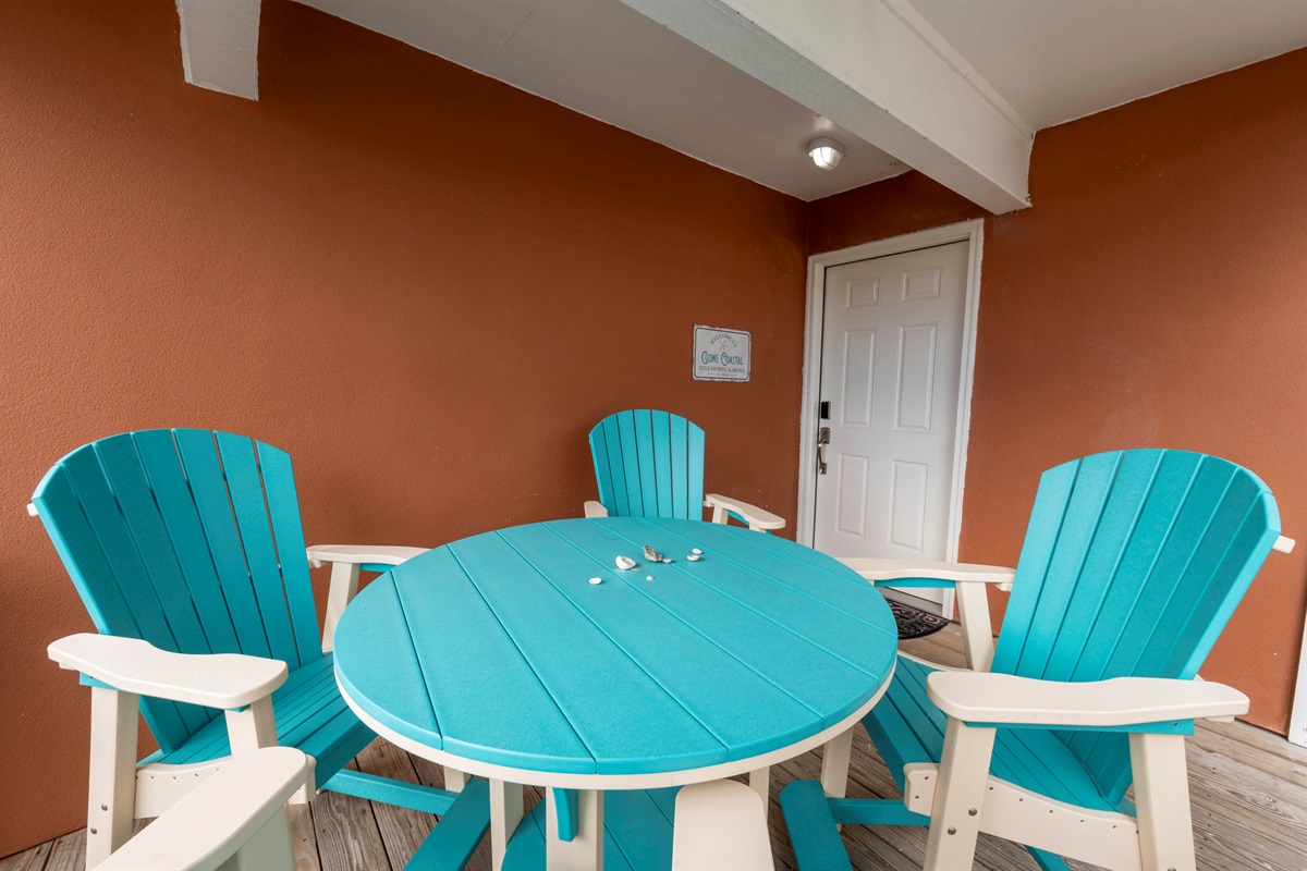 Gone Coastal’s unique turquoise porch furniture - a cheerful, welcoming touch at the front entry.