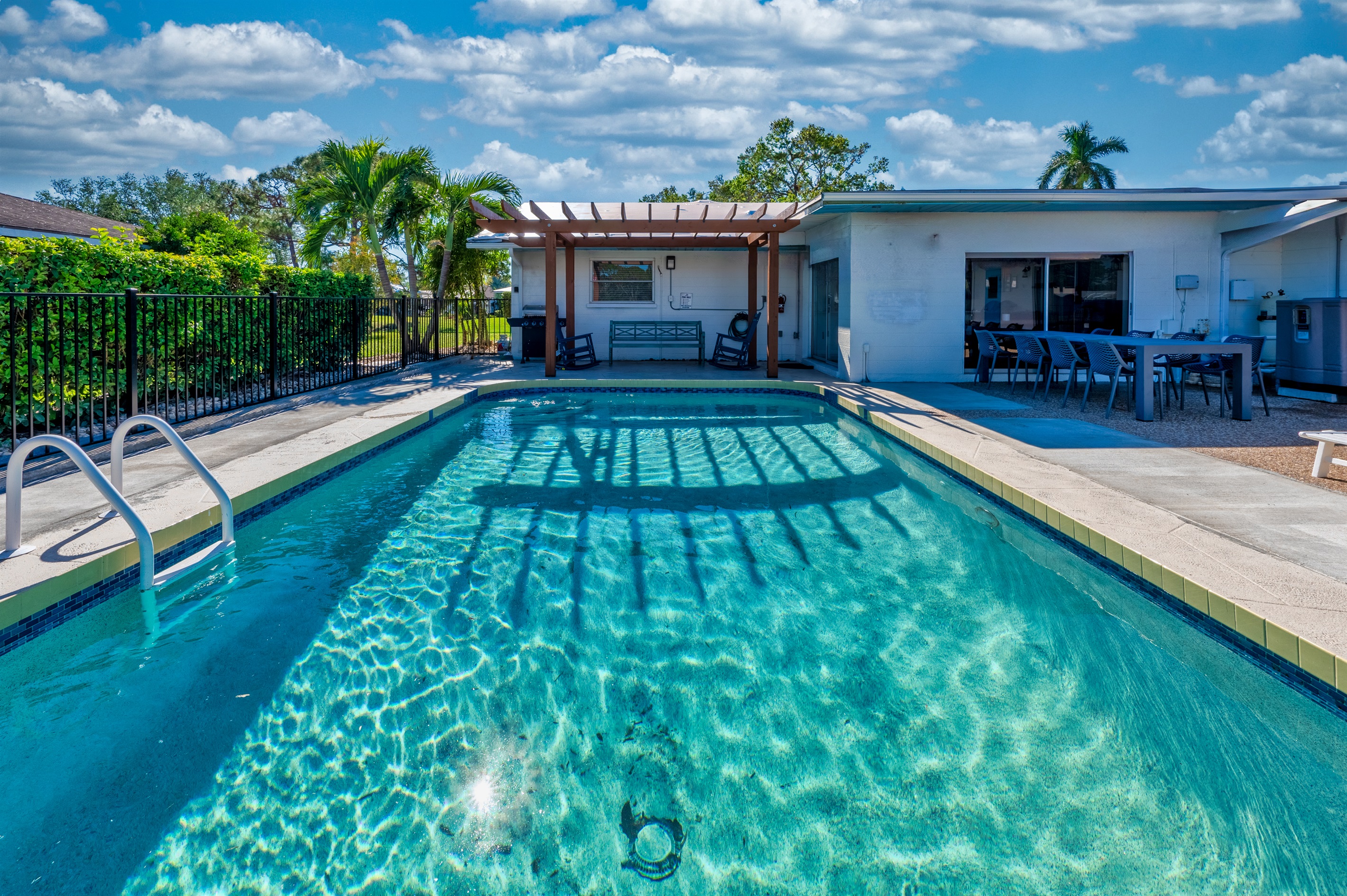 Our outdoor dining area, shaded and with perfect view of the pool.