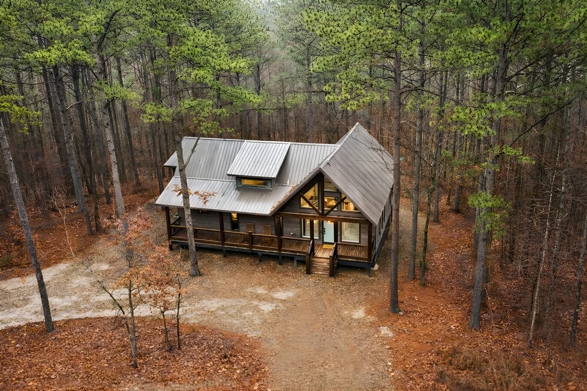 From above, our cabin's unique charm and beautiful setting among the trees are truly breathtaking.