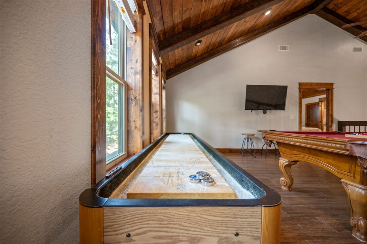 Table shuffle board in game room