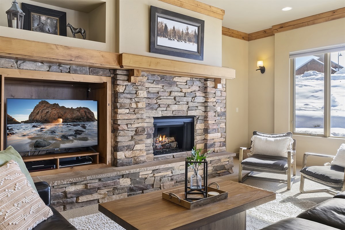 Cozy up by the fire with a movie or good conversation in this beautifully designed living space.