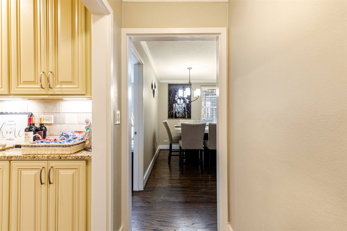 A stunning entrance reveals the kitchen and dining area, where elegant design meets inviting comfort.