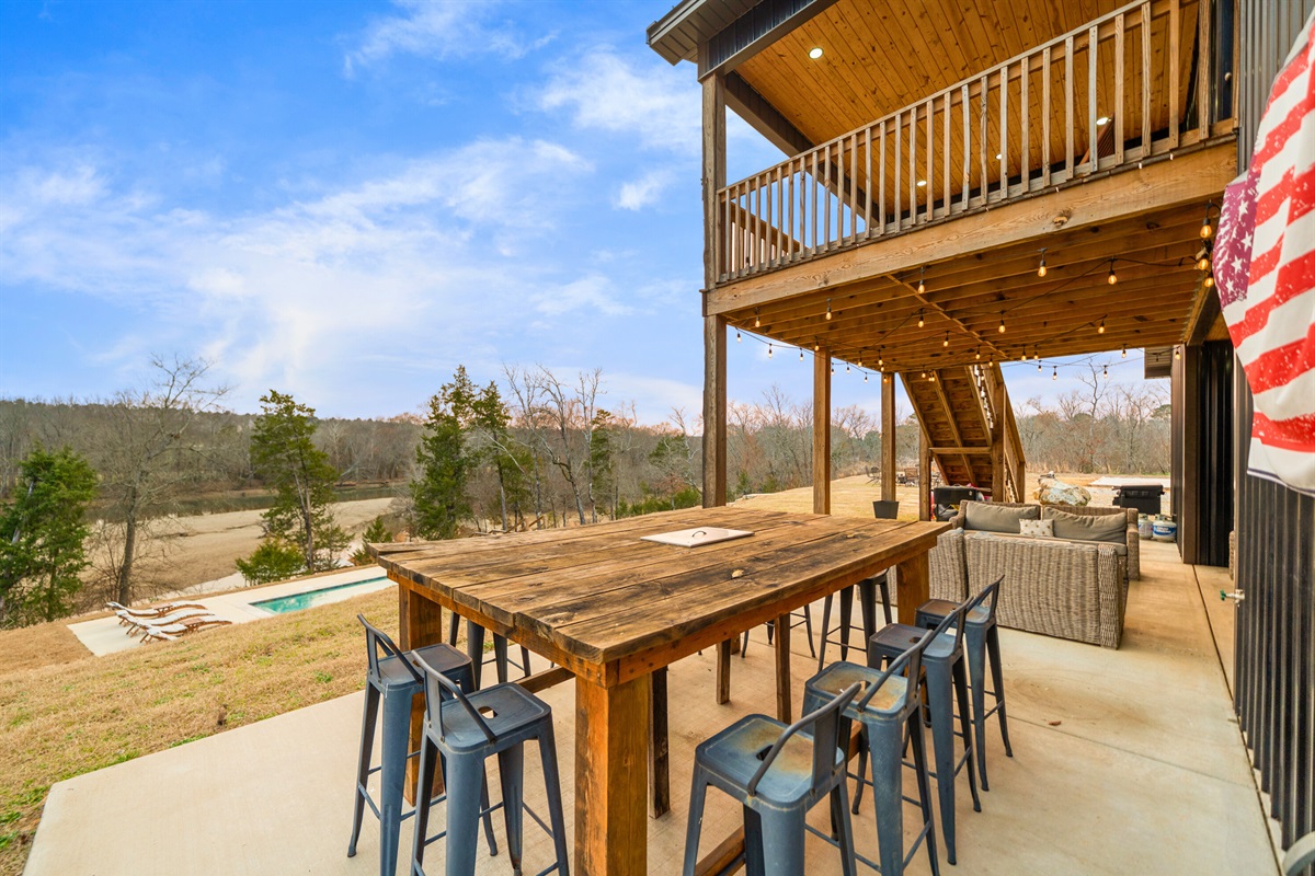 The outdoor bar-height seating area offers a fun place to sip drinks, share stories, and enjoy the open air.