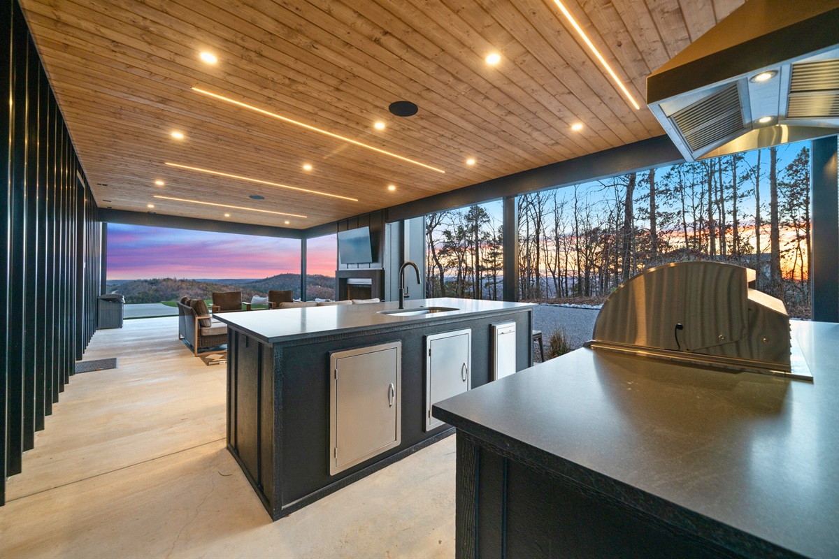 A closer look at the outdoor kitchen area shows off the spacious counters and bar seating, making it so easy to gather everyone together outside.