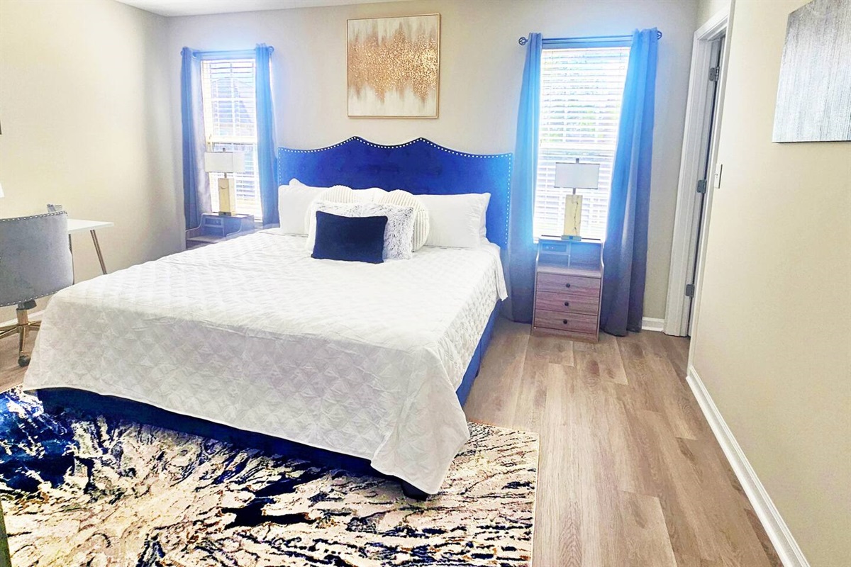 King size bed  with storage for clothes and dedicated work space. 
