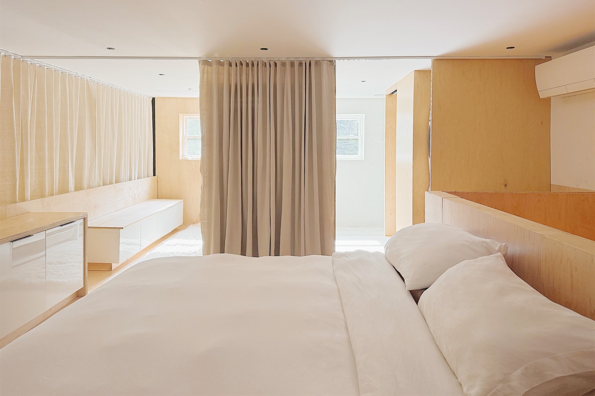 King sized bed with pressed Parachute linens.
