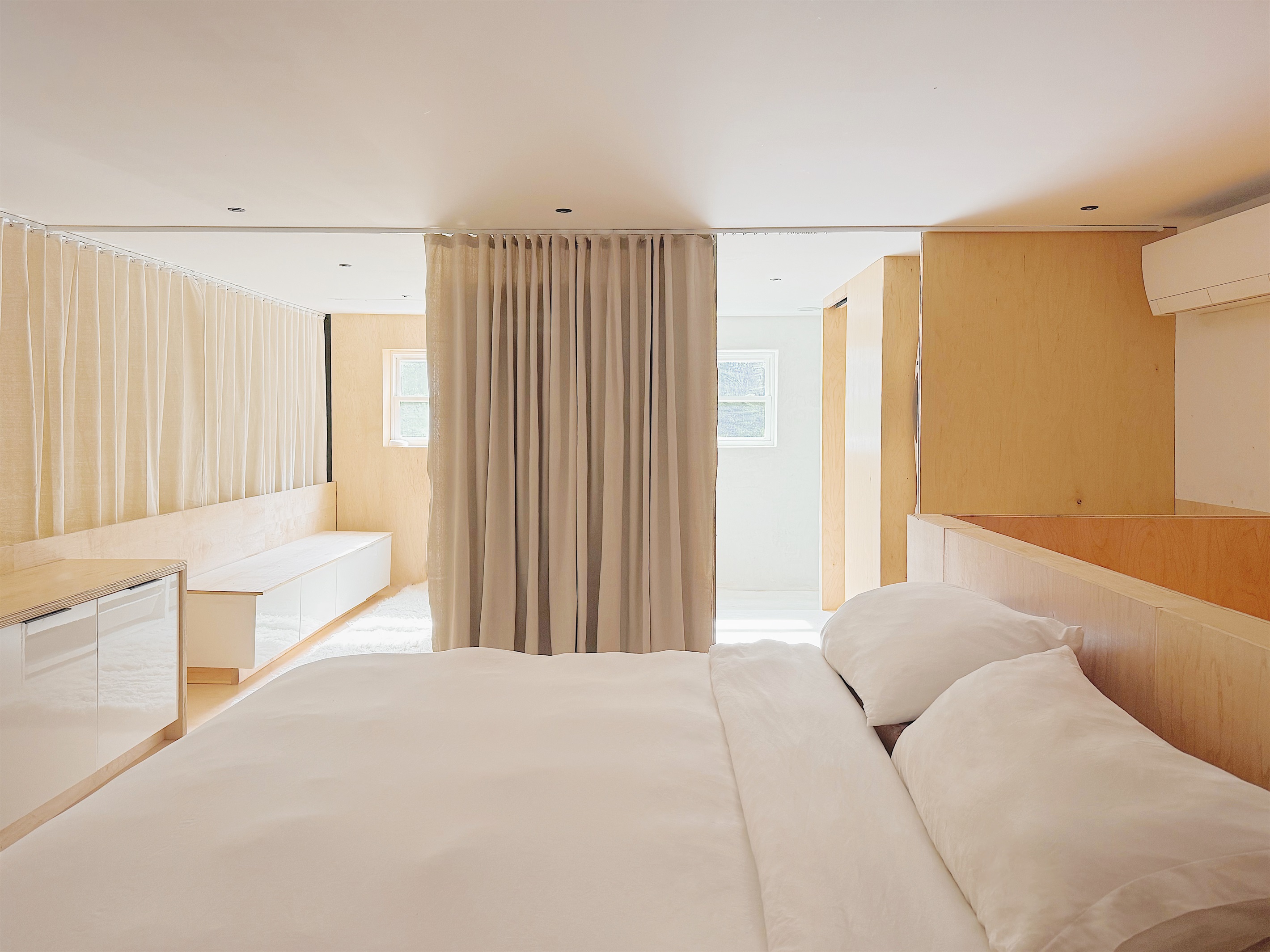 King sized bed with pressed Parachute linens.