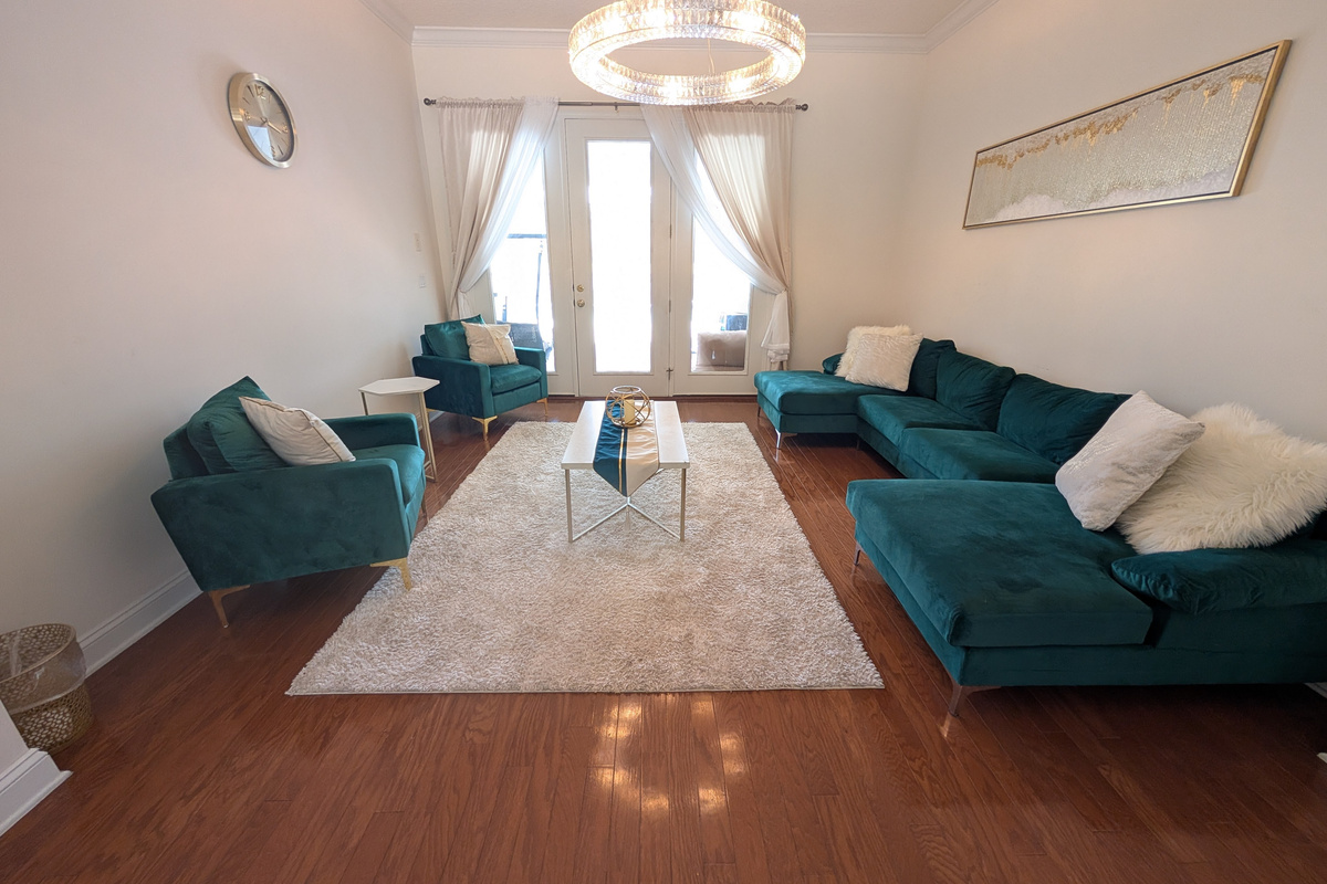 Bright second living area with comfortable seating &mdash; perfect for conversation, relaxing, or spreading out.