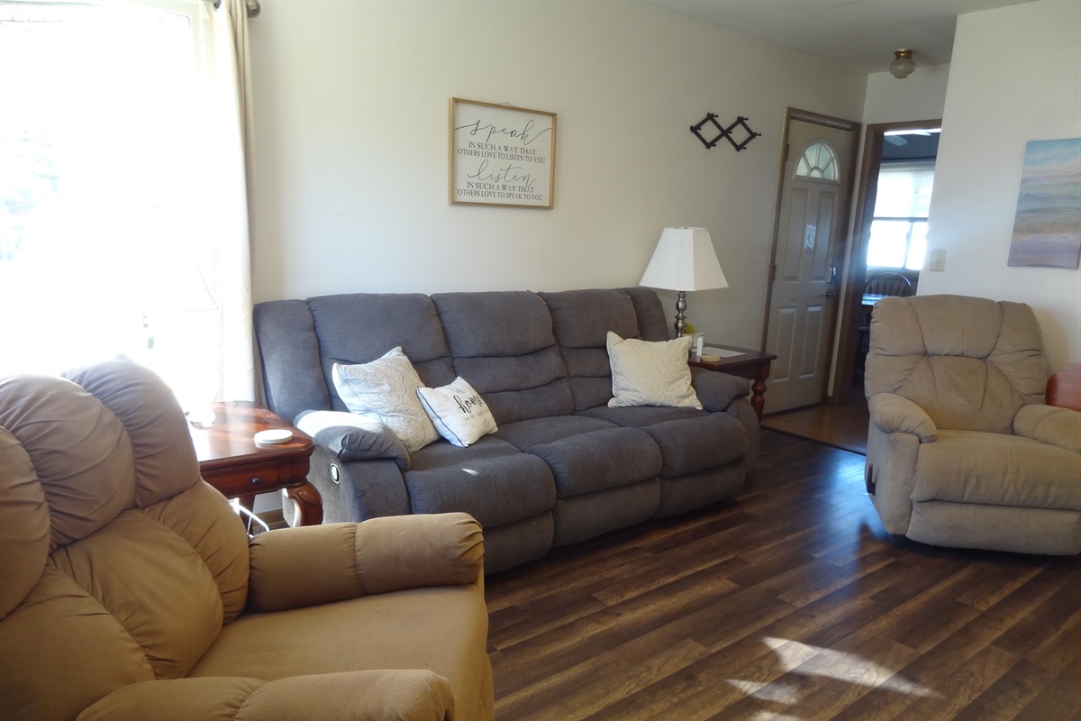 Living room with 2 recliners, reclining couch and Roku smart TV