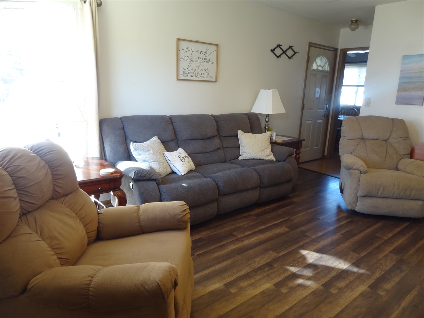 Living room with 2 recliners, reclining couch and Roku smart TV