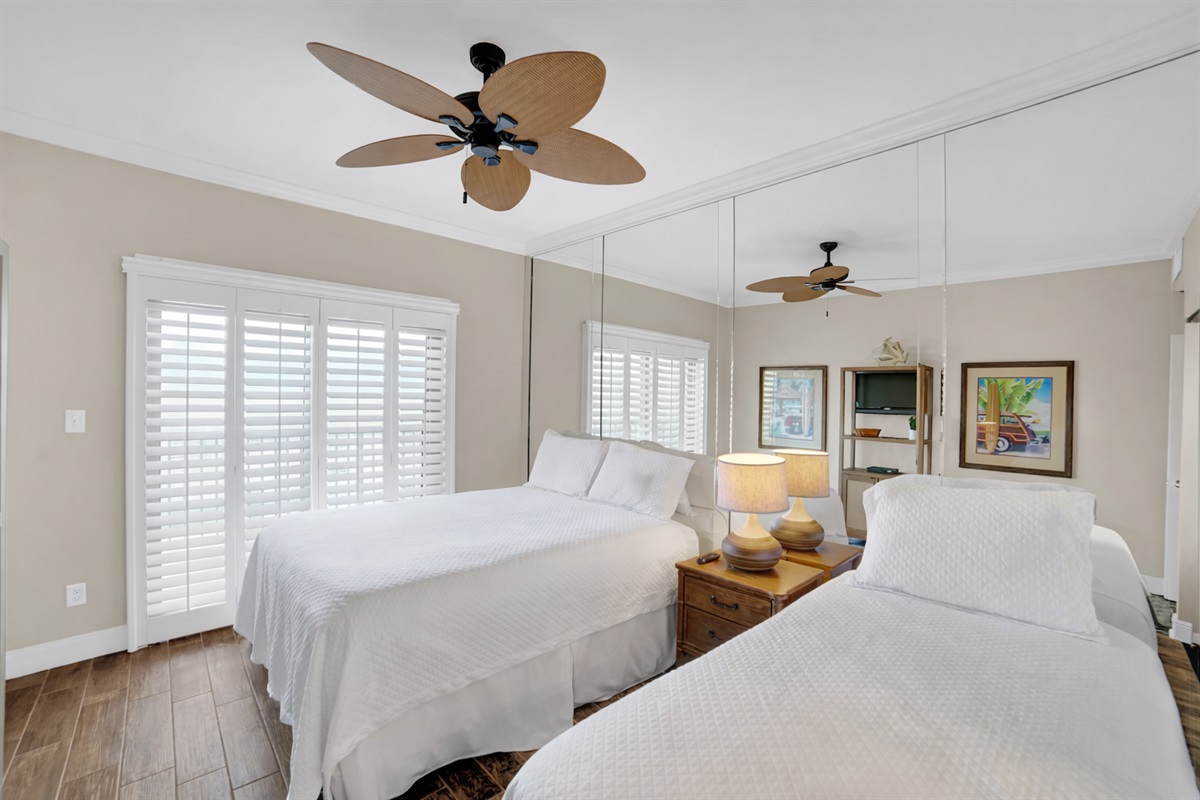 Guest bedroom will accommodate 3 guests. I will be removing the mirror wall, putting a new fan with light kit in, wall mounting a smart tv and a vanity. This room has direct access to a private balcony that is only accessed through this room.  