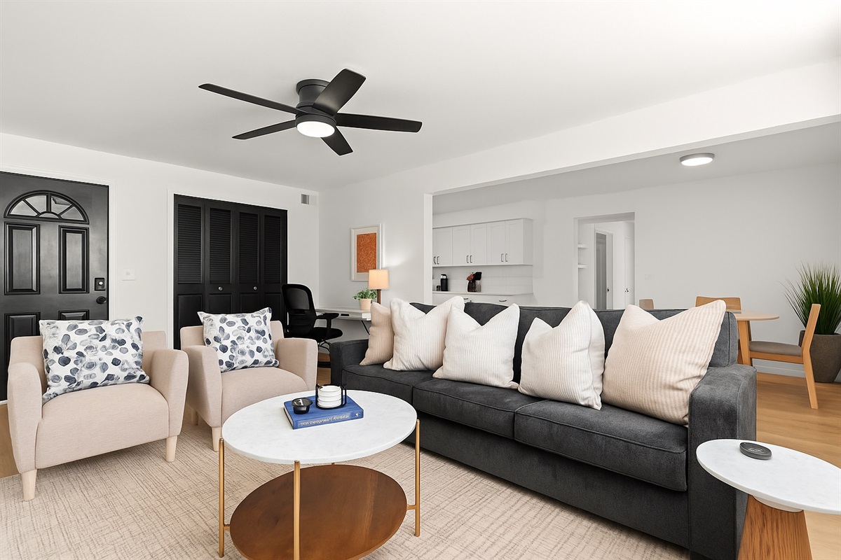 Spacious living room with plush seating, stylish décor, and a Smart TV—perfect for relaxing after a day out.