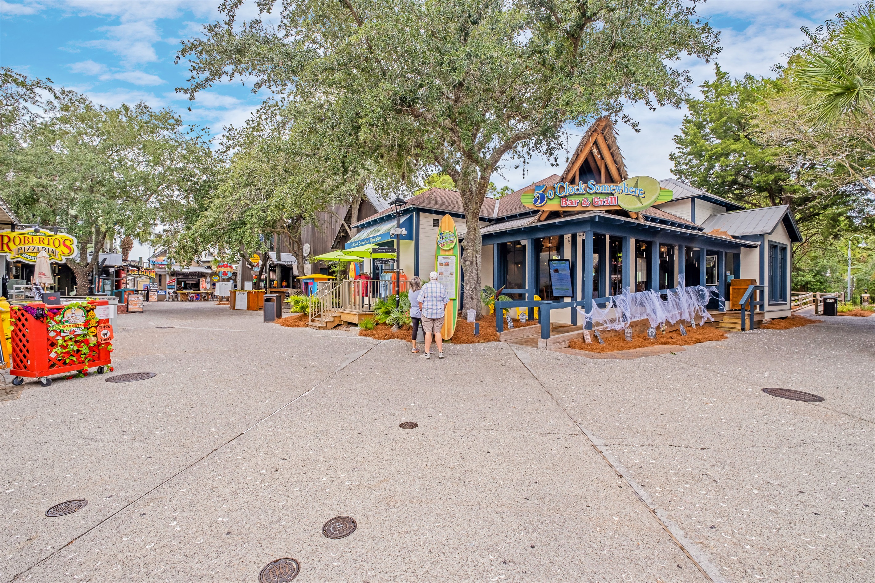 Local favorites like 5 O'Clock Somewhere Bar & Grill and boutique shops line this friendly pedestrian area, perfect for grabbing a quick bite or souvenir.