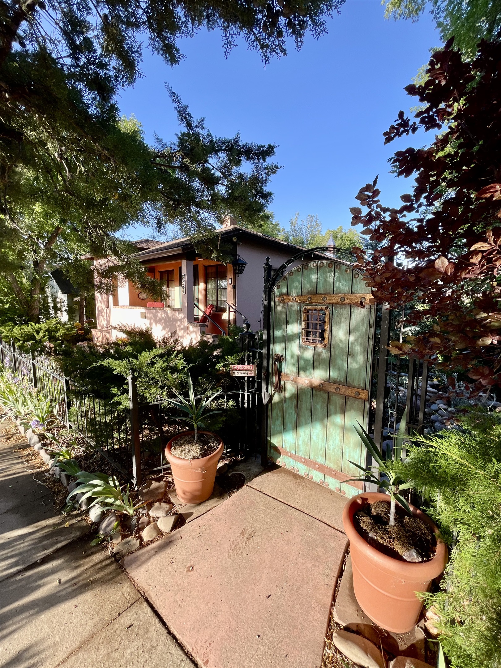 Step through this enchanting green gate and discover a hidden oasis.