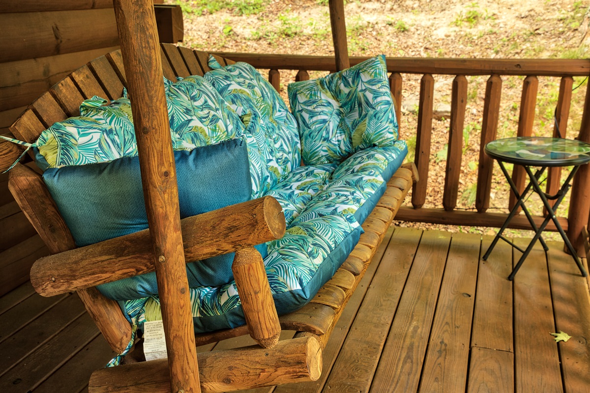 The cabin’s front covered porch invites you to relax in the swing!