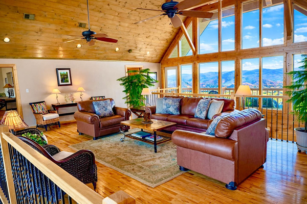 Queen sofa bed and sitting area with floor-to-ceiling mountain views, Tanasi Lodge