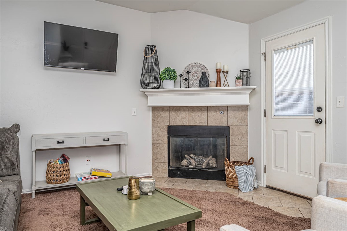 Inviting living room with smart TV, fireplace, and plenty of comfort.