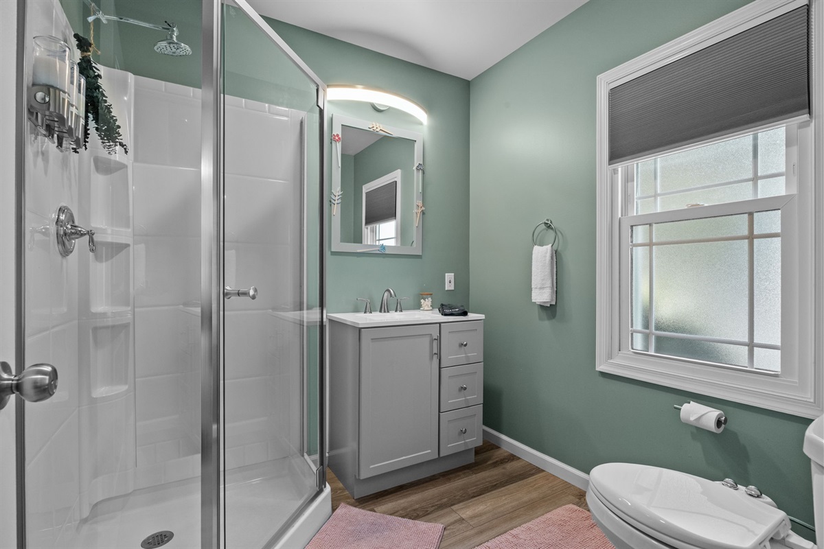Fresh, modern, and sparkling clean! The hall bathroom features a spacious shower and plush towels for a relaxing stay