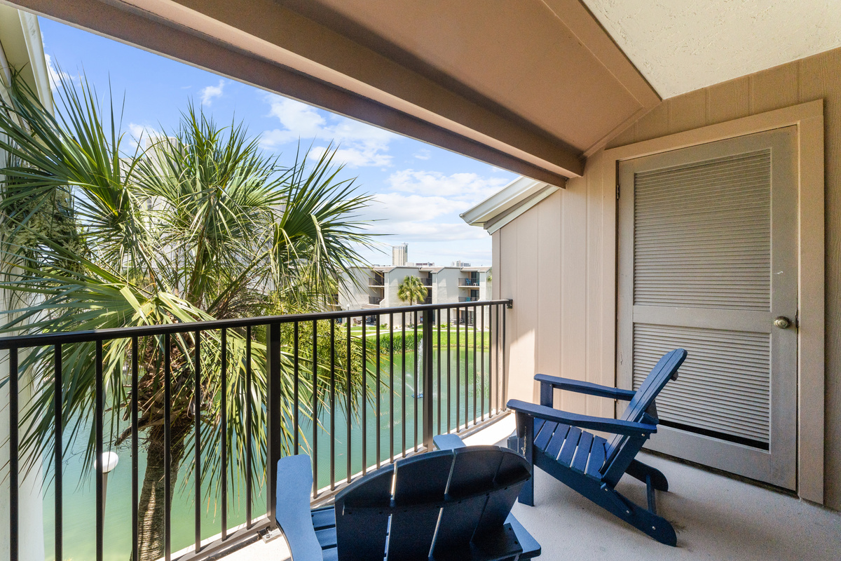 Balcony off of Bedroom 1 with outdoor seating. 