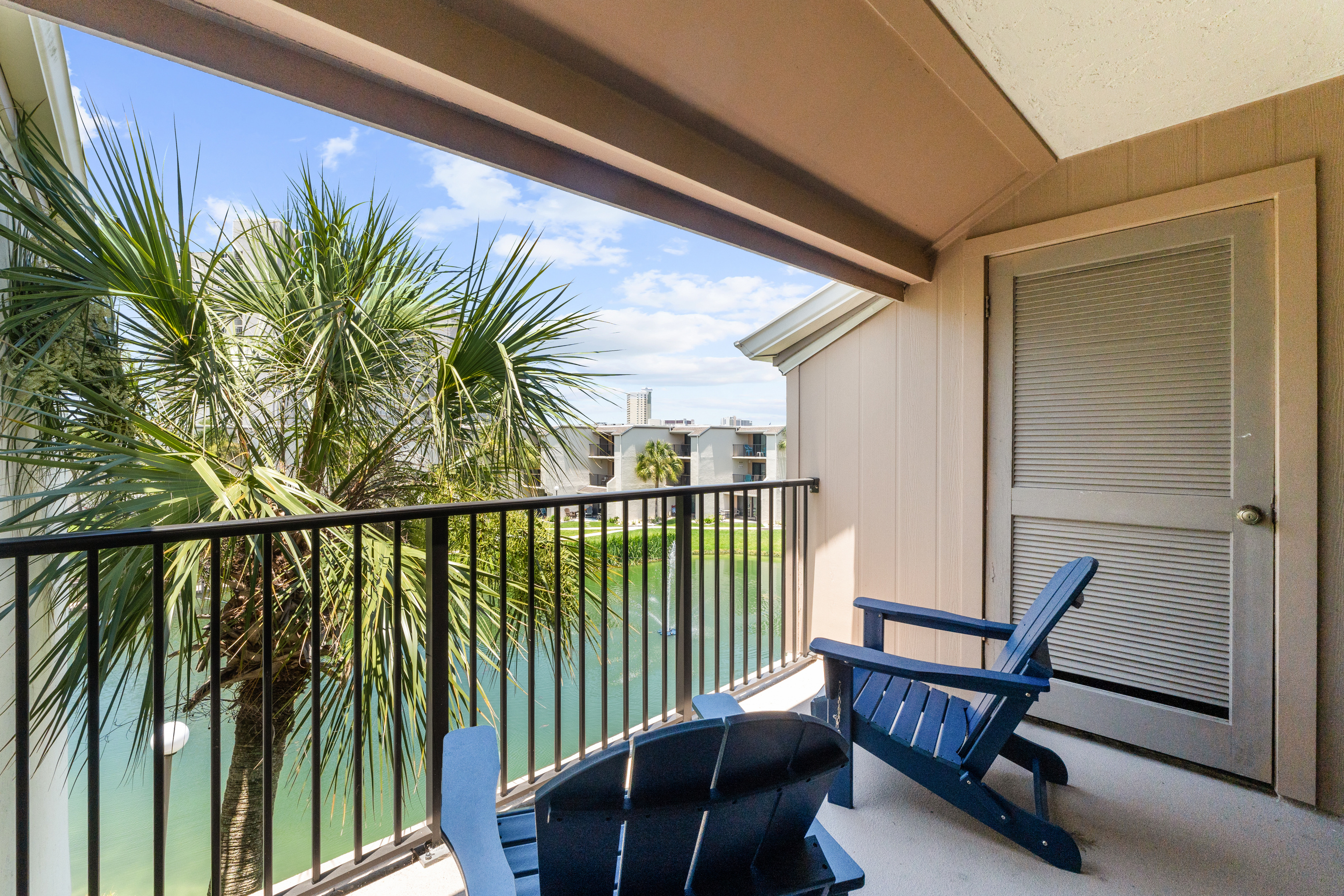 Balcony off of Bedroom 1 with outdoor seating. 