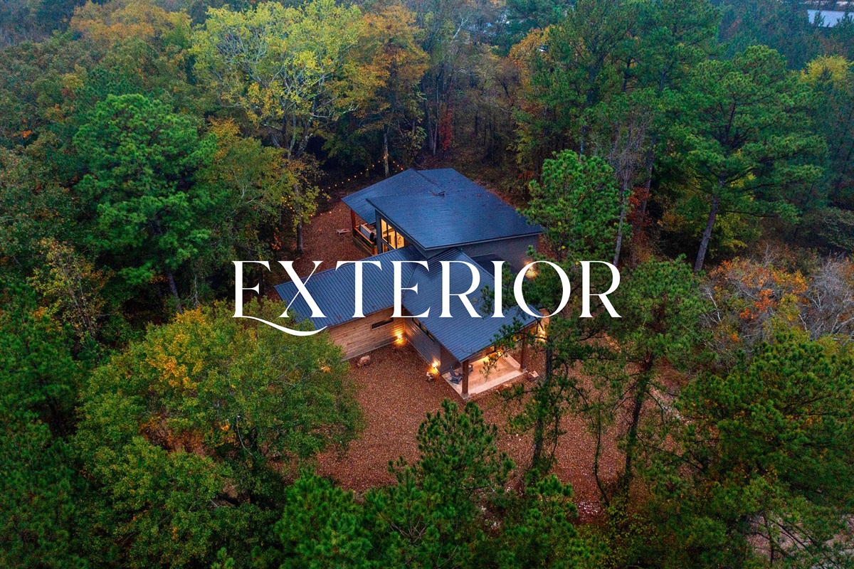 Tucked into the trees, this wide aerial shot shows just how private and peaceful the property really is.