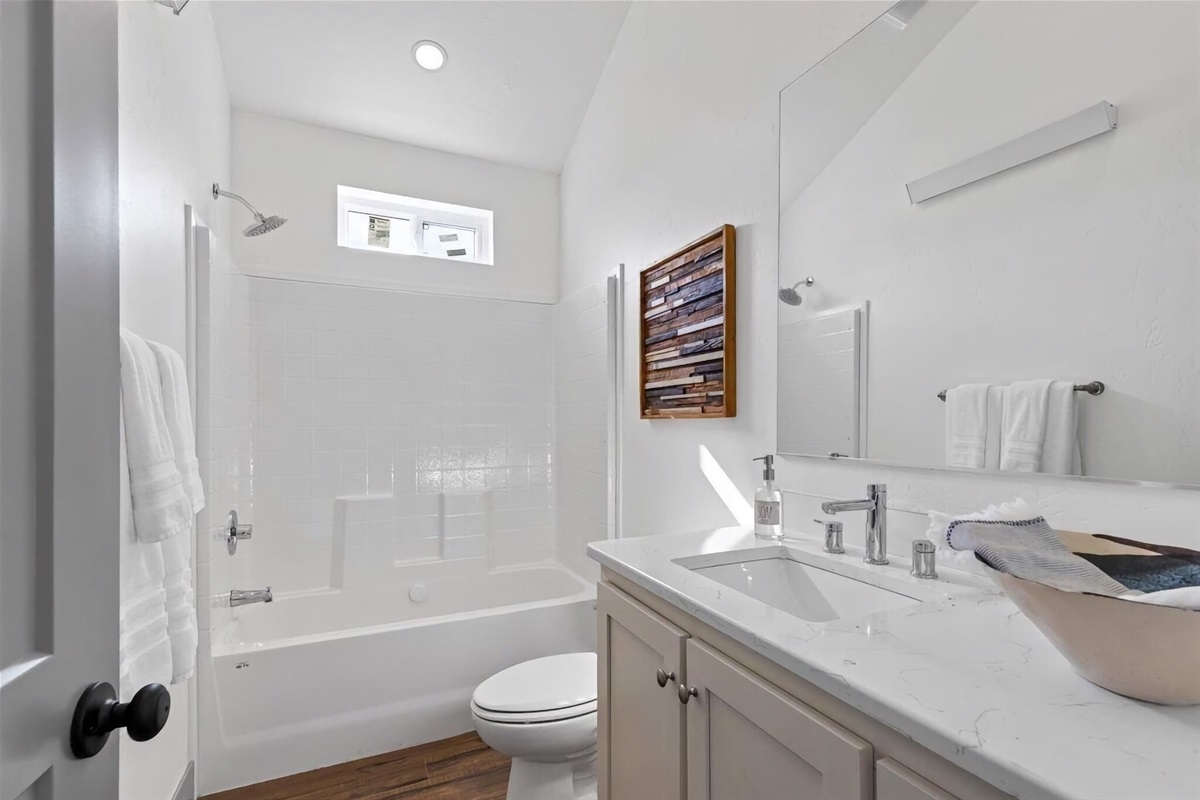 The other full bathroom, shared by Bedroom #2 and the common living area, has a large tub/shower combo and a large vanity.
