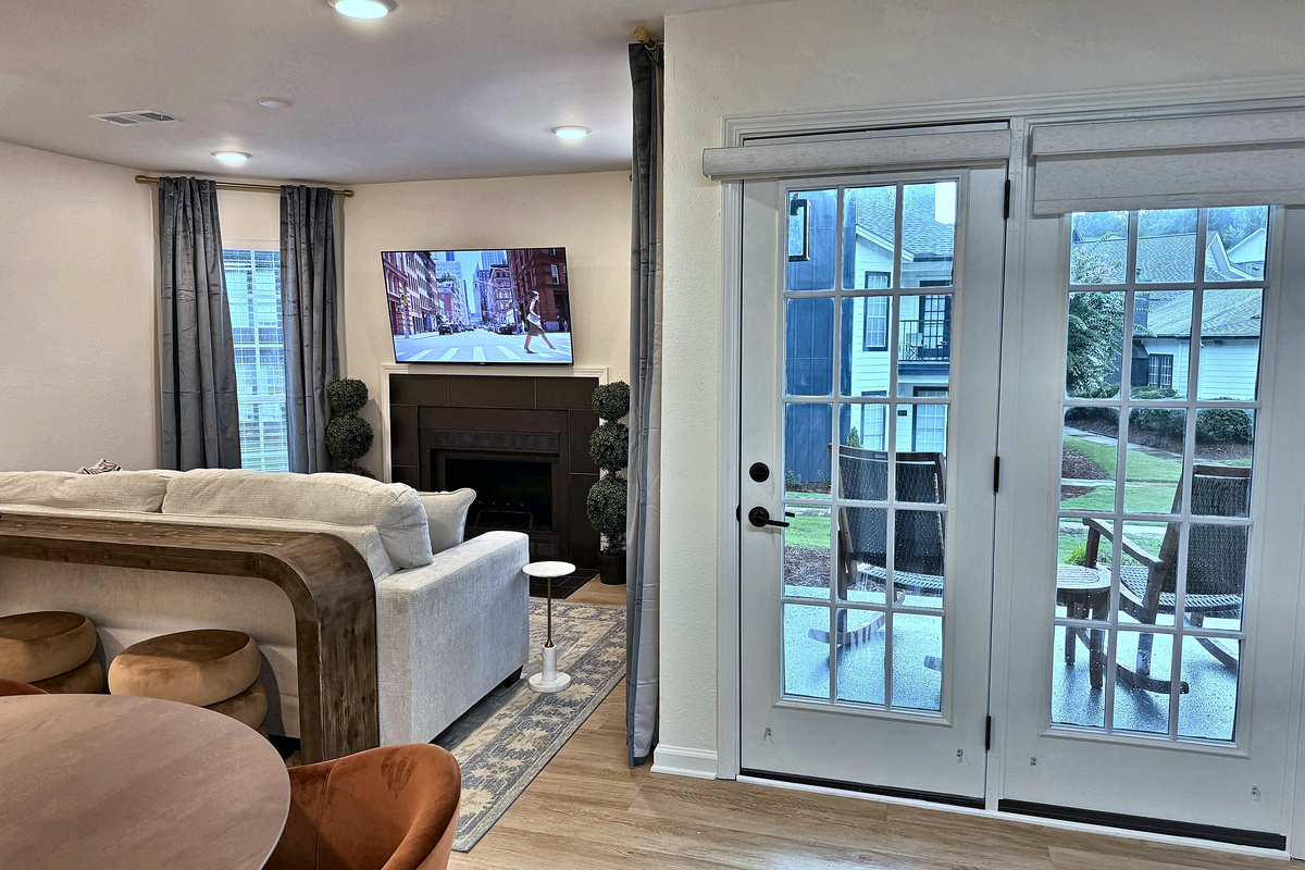 French doors open straight onto the patio and the pool green