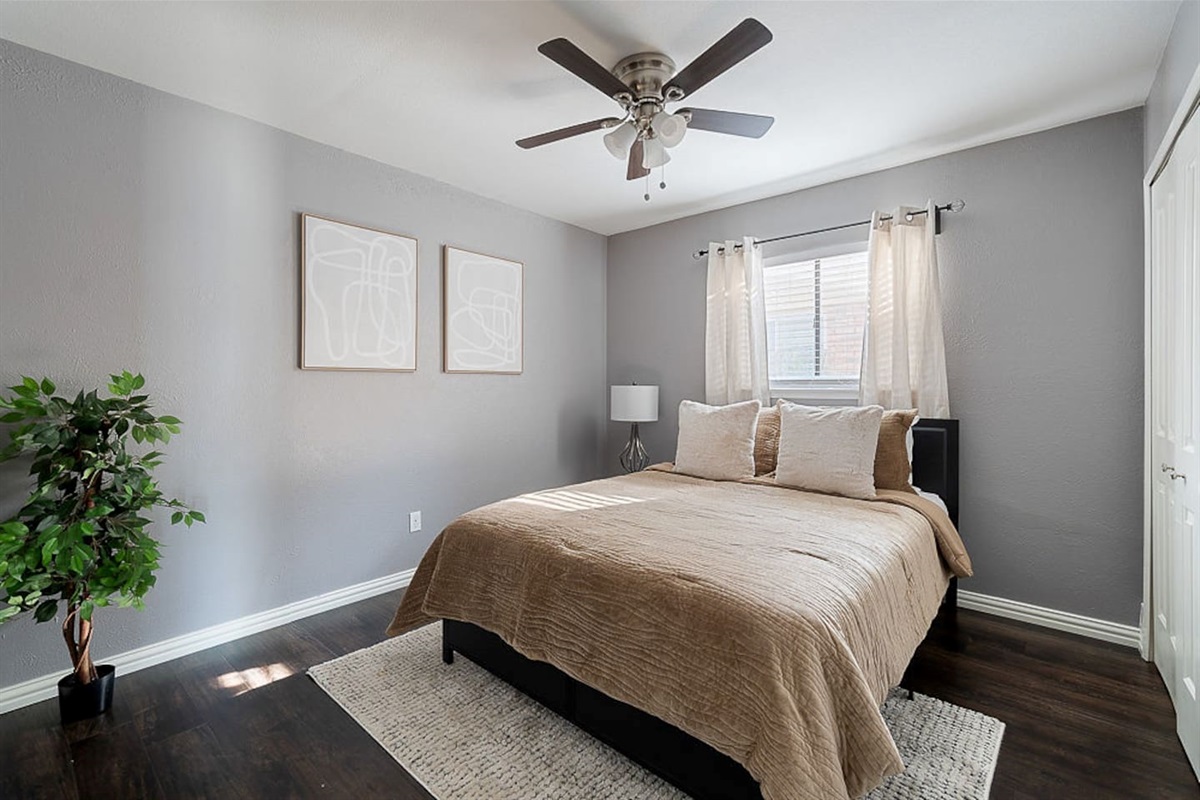Find serenity in this beautiful bedroom featuring natural light, a comfy double bed, a nightstand and a lamp for your relaxation