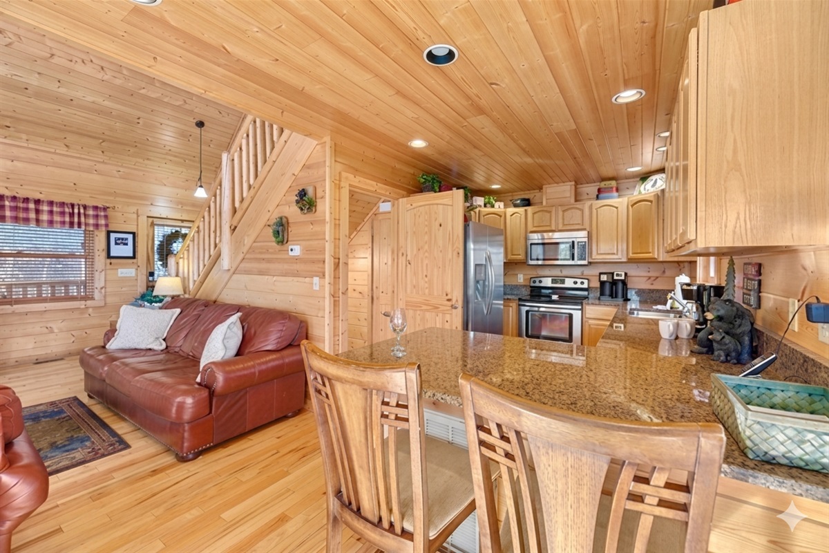 Gather in this bright and welcoming space where the kitchen, dining, and living areas come together. Perfect for cooking, chatting, and sharing laughter after a day in the mountains.