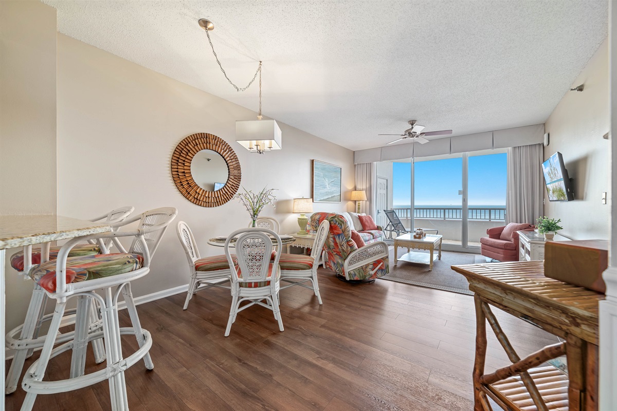 Subtle coastal touches and a neutral palette create a serene and relaxing ambiance in this open living and dining space.