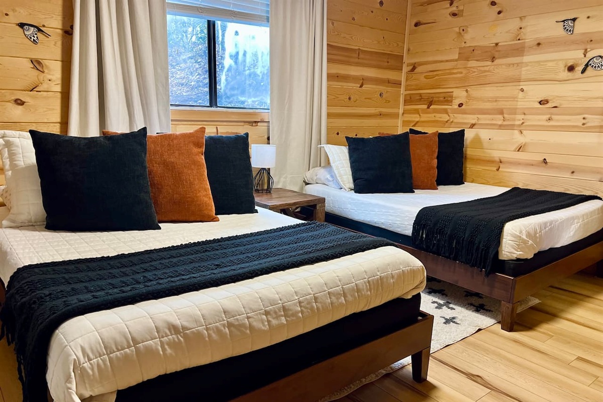 Three of 5 bedrooms pictured, featuring two full-sized beds (sleeps up to 4 people) and a Roku streaming TV.