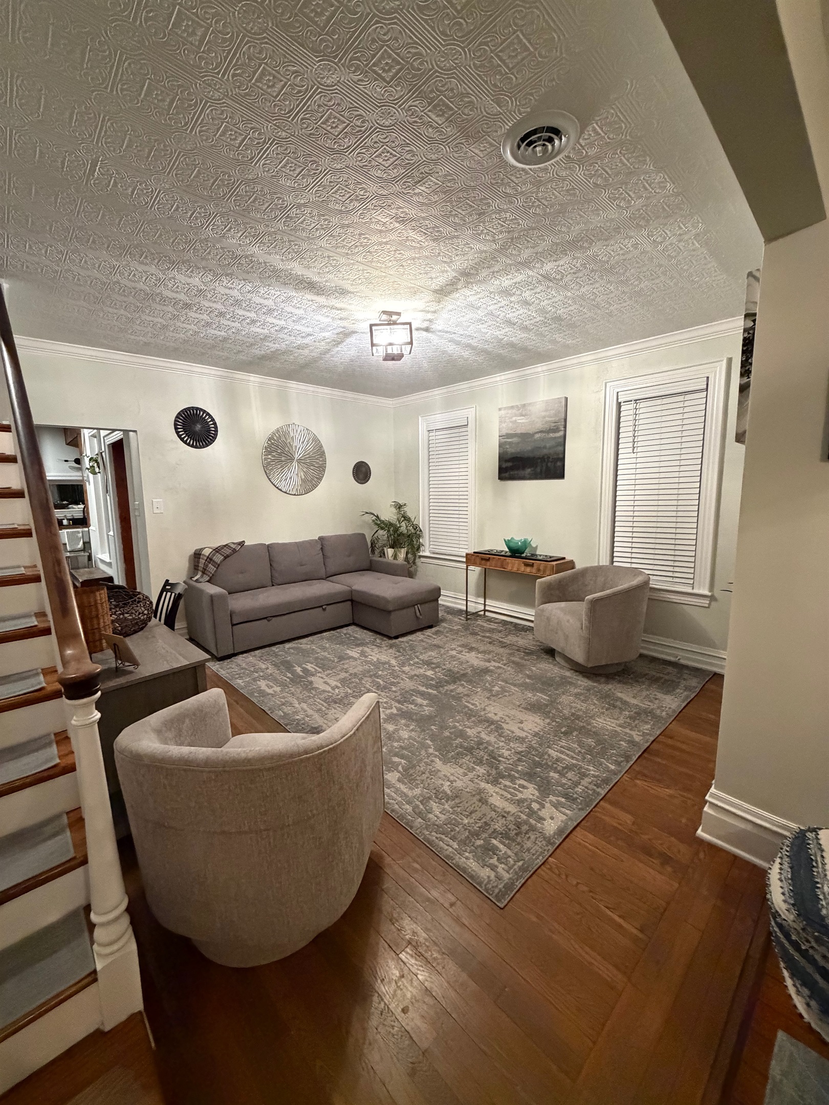 secondary living room with a sleep pull out couch and accent chairs.