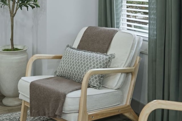 Another view of the inviting lounge chair by the window—an ideal spot to sit back, relax, and enjoy the peaceful atmosphere.
