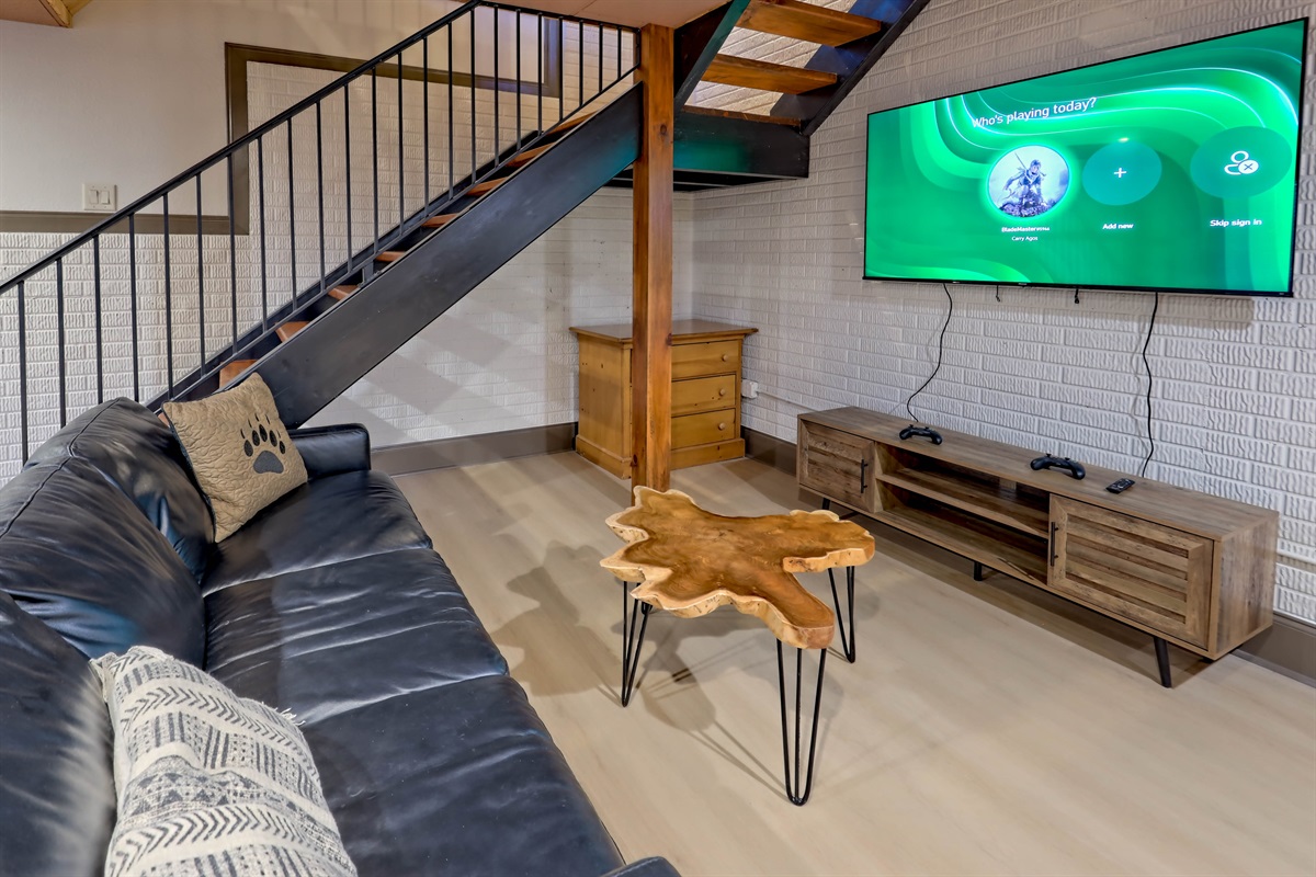 Comfortable hangout space featuring an Xbox and large TV.