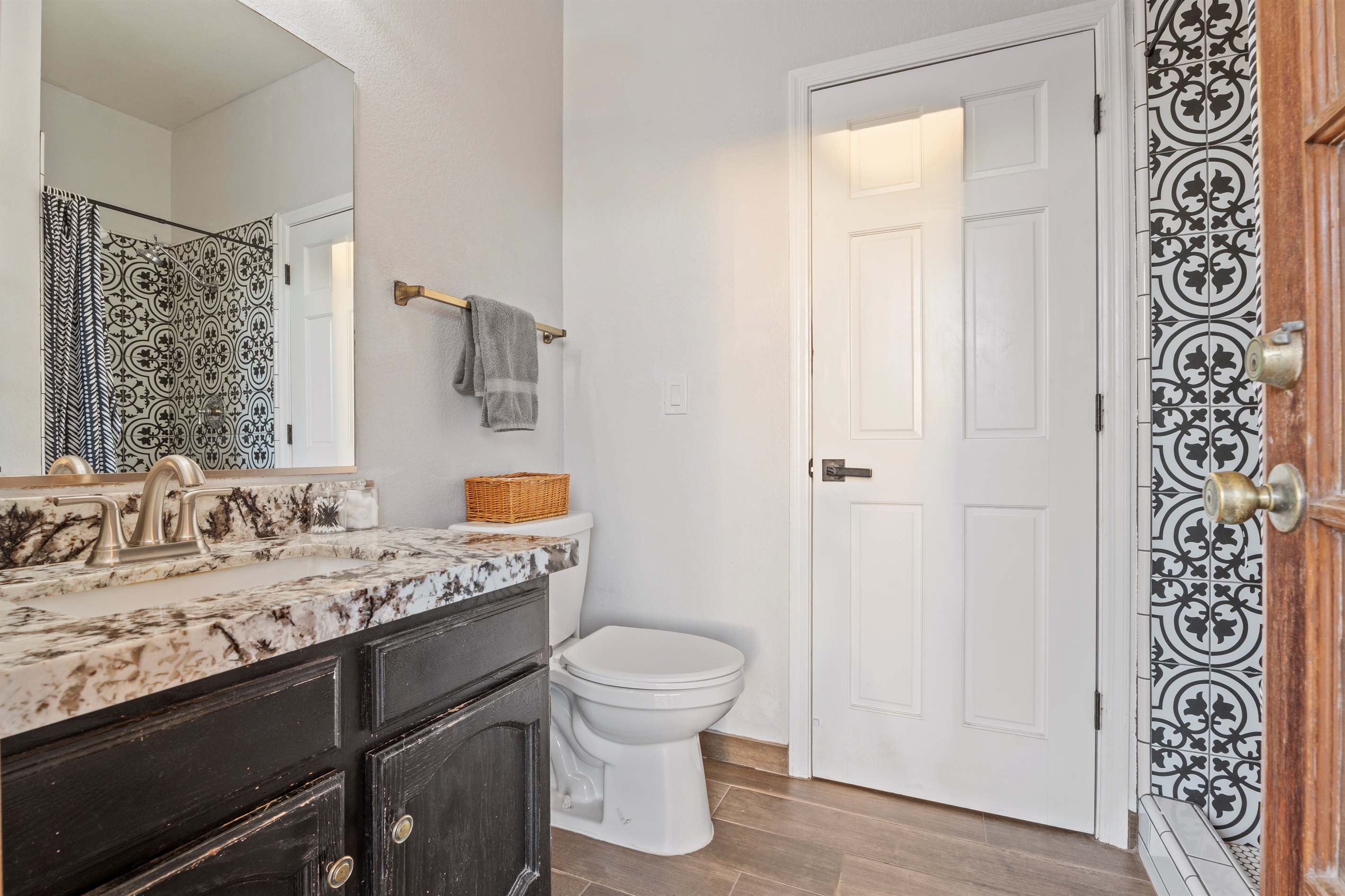 Elevate your stay with this chic bathroom featuring custom tile, a stone countertop, and a spa-style shower experience.
