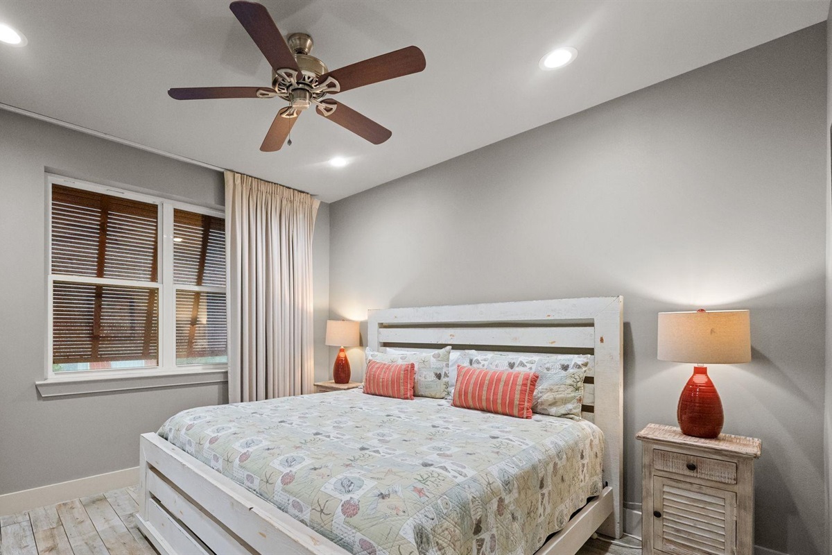 Bedroom with king bed, ceiling fan, TV and en-suite bathroom 