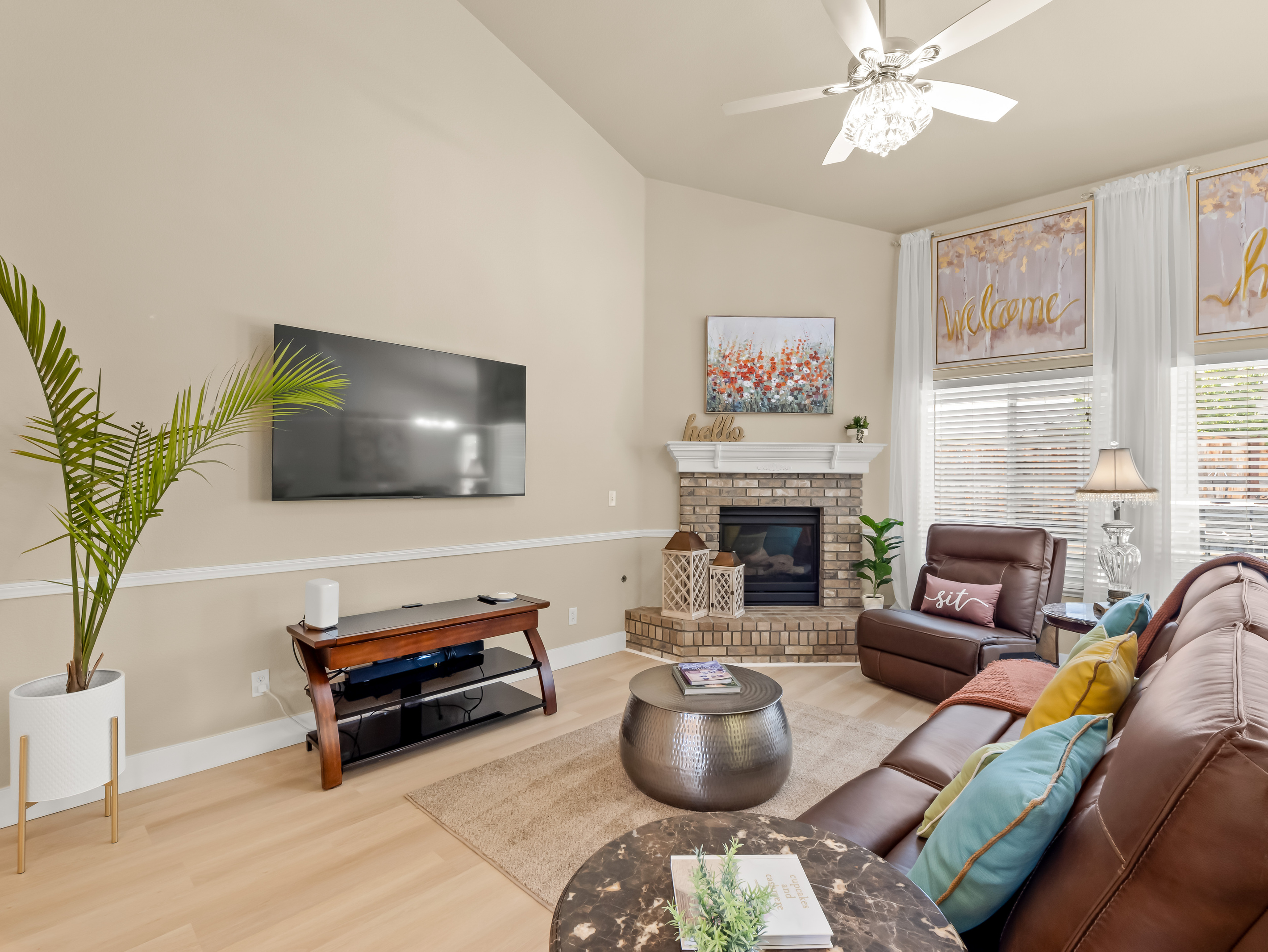 Spend quality time with family and friends in this inviting living room, where natural light pours through oversized windows and the fireplace creates the perfect atmosphere for relaxing evenings at home.