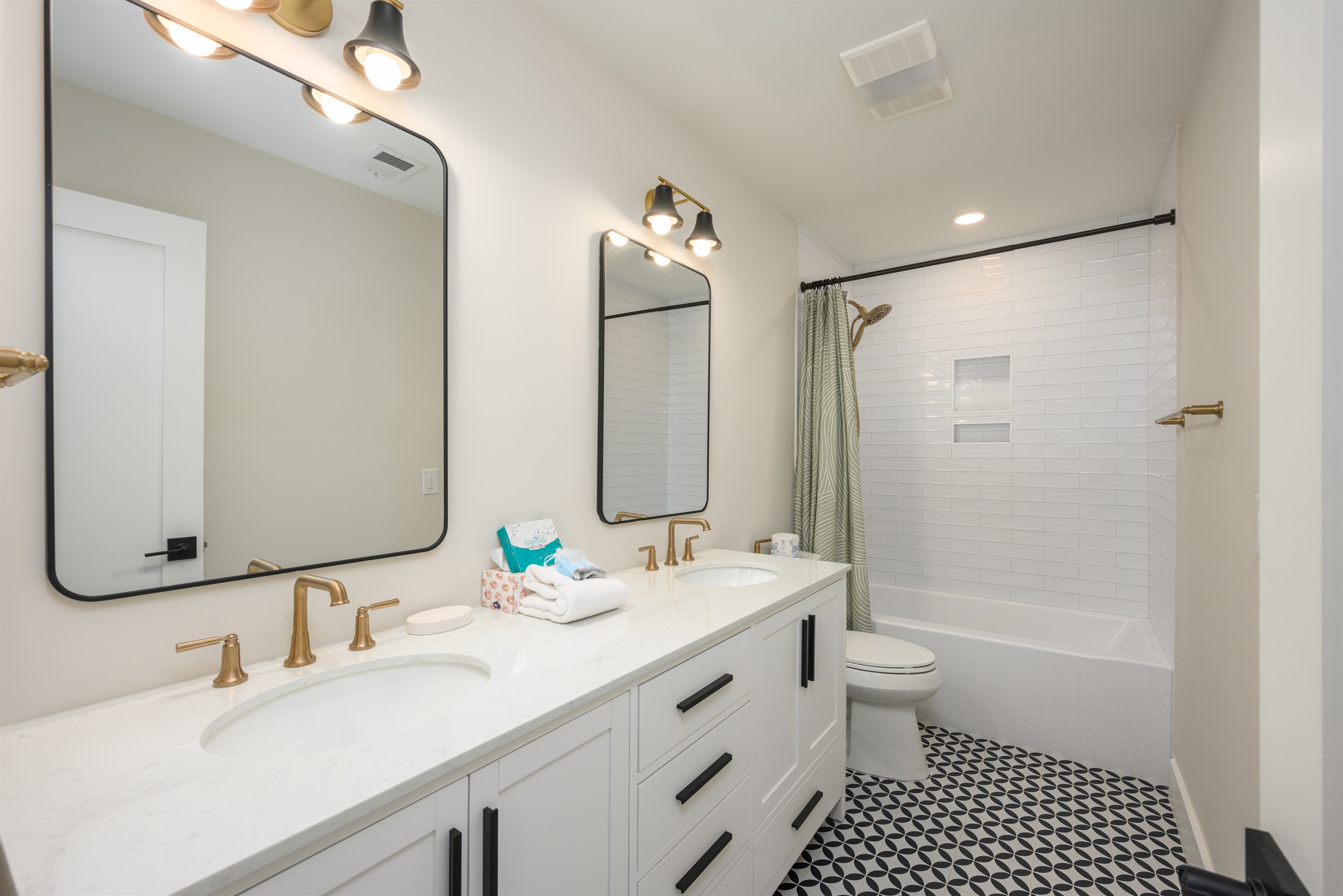 2nd full bathroom features dual sink vanity, bathtub with shower