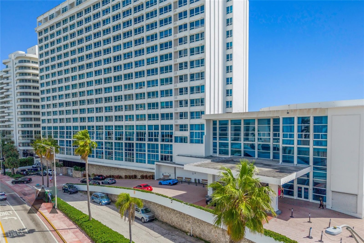 The Castle Beach Club entrance on Collins Avenue, home to the valet driveway and the main lobby Welcome Center.